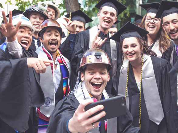 Mackay students grouped together taking a selfie at graduation