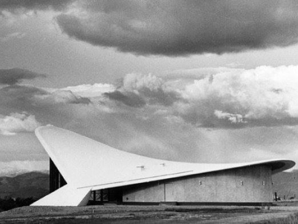 Outside the Fleischmann Planetarium, with puffy white clouds lining the sky.