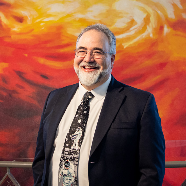 Paul McFarlane in front of Full-Dome Theater exterior at Planetarium