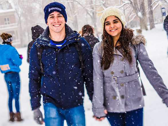 Students in the snow holding hands