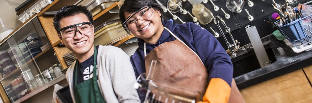 Two graduate assistants working in a lab