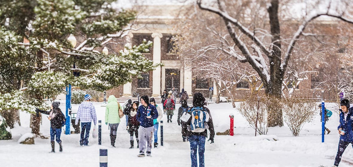 Snow-covered University campus with students
