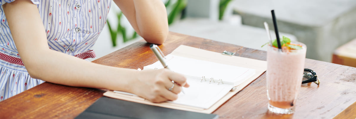 Student writing in her planner