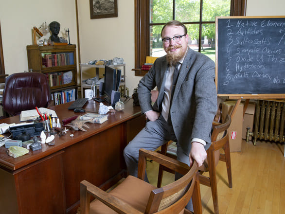 Garrett Barmore posing in his office in the Keck Museum