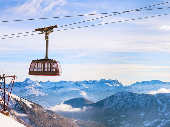French Alps Chamonix Cable Car with white mountains in the back.