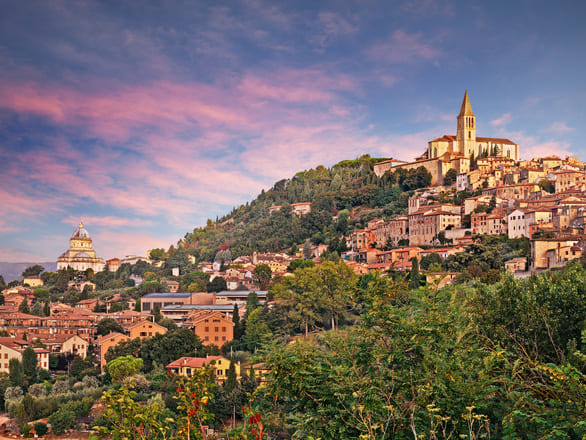 Landscape at dawn of the medieval hill town of Todi in Perugia, Umbria, Italy, bathed in soft morning light.