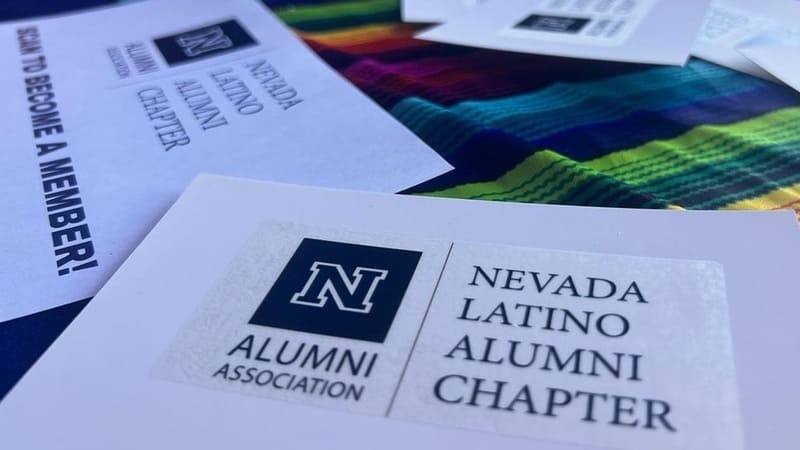 Nevada Latino Chapter memership literature on a colorful table cloth