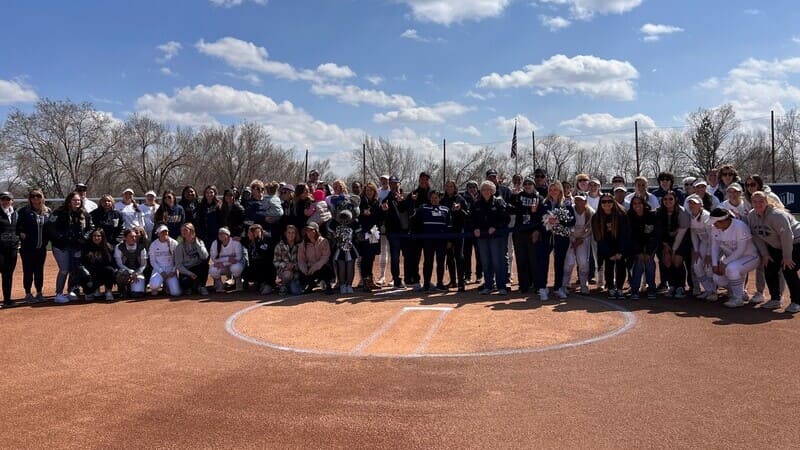 Softball Alumni Chapter posing together on the field