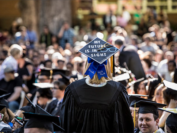 Woman in regalia with mortar board that reads my future is in sight