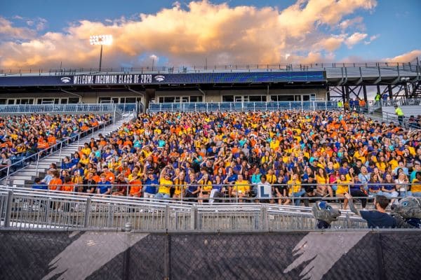 NevadaFIT students, joined by their families and mentors, gather inside Mackay Stadium for the NevadaFIT Opening Ceremony Saturday, Aug. 16. The colors of the students’ shirts represent the schools and colleges they’ve joined — based on their chosen majors — and illustrate the vibrant, college-before-college program that builds academic readiness and Pack Pride.