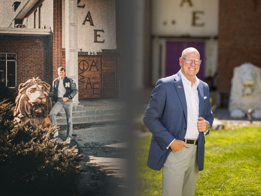 Don Bernard is positioned next to a golden lion statue in front of a fraternity house. 