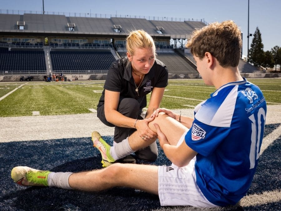 Zoe Haddox demonstrates sideline response on a young soccer player.