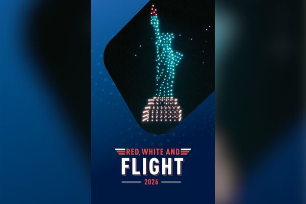 A drone light display forms the Statue of Liberty against a dark sky. Below, text reads 