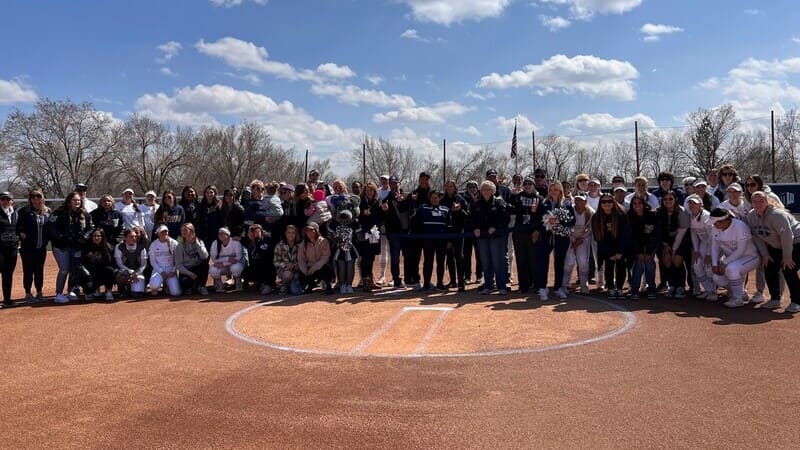 Softball Alumni Chapter posing together on the field