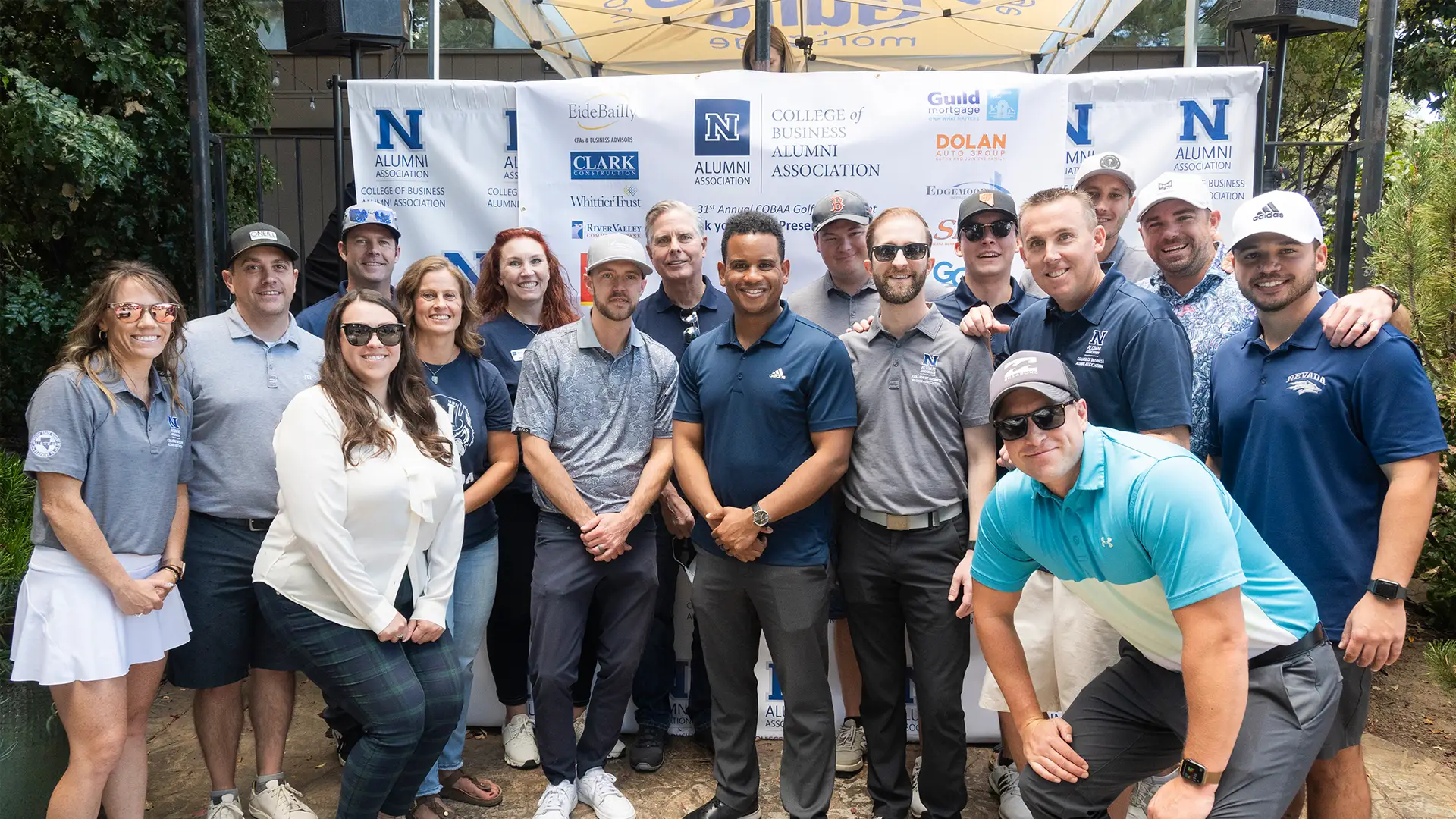 Members of the College of Business Alumni Chapter pose in golf attire at a golf tournament.