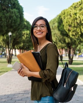 Girl holding books.