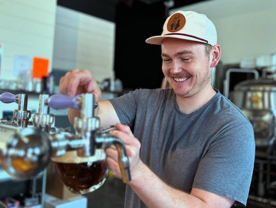 Ryan Dunlap pours a beer from a tap.