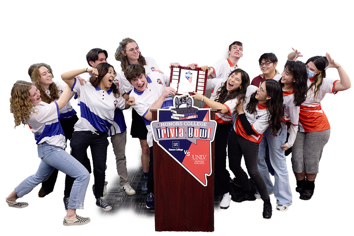 A group of University students (left) and UNLV students (right) fake argue over the Honors College Trivia Bowl trophy.