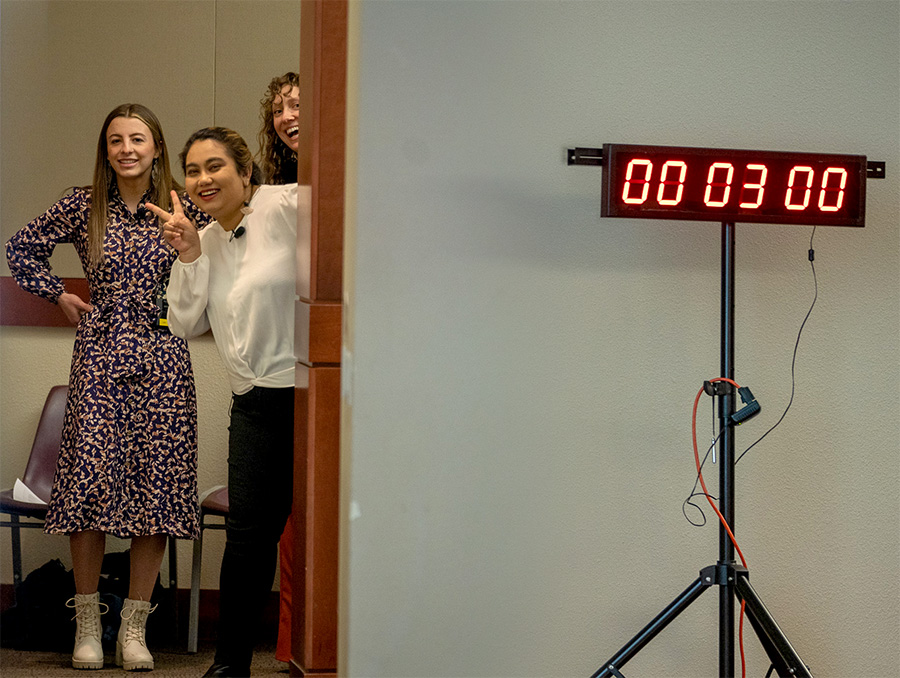 Three graduate students waiting backstage in anticipation to compete in the 3MT Competition. From left to right, Justice Best ’20 (geological sciences), ’23 M.S. (geography); Fatema Azmee ’16 (international affairs), ’17 (economics), ’24 M.A (history) and Candi Block ’23 M.A. (sociology).