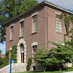 Exterior view of Clark Administration building with brick exterior and ivy running down the sides of the building