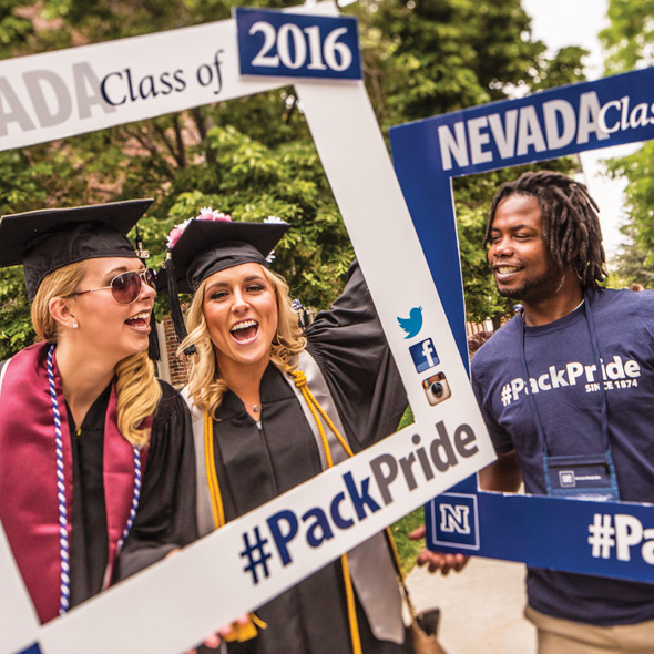 female students and male student smiling during commencement
