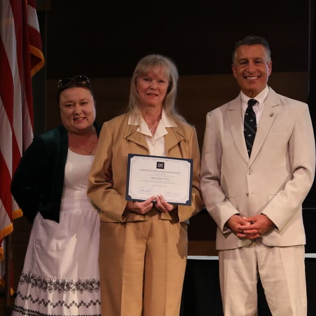 Marilyn Fry receiving her award from President Brian Sandoval