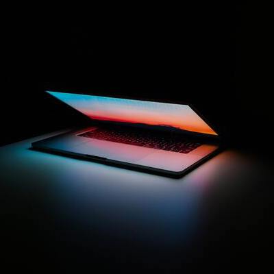 Laptop computer open on a desk.