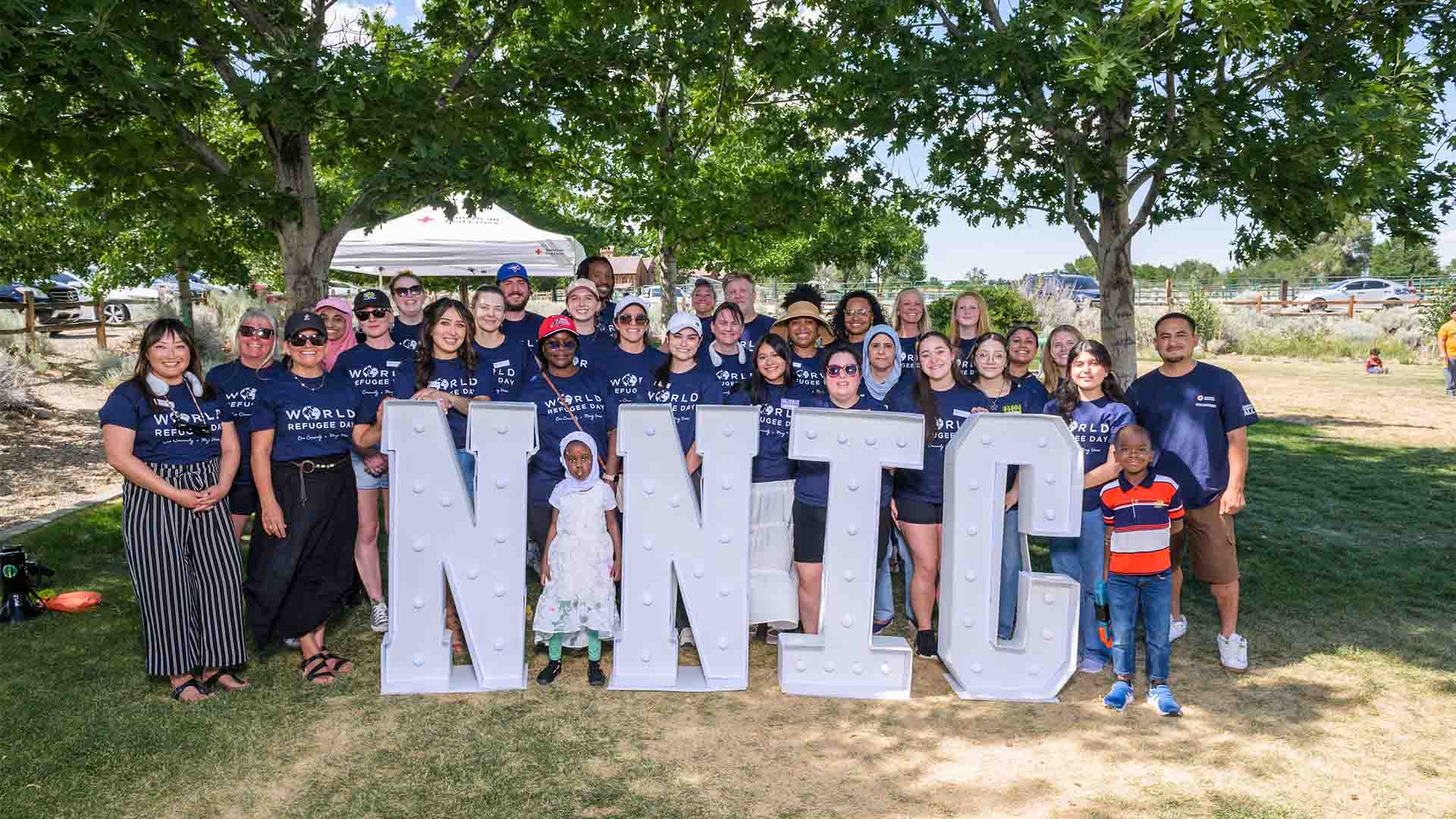 World Refugee Day group picture under trees