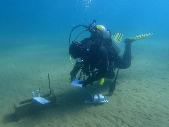 A scuba diver takes algae samples at the bottom of Lake Tahoe.