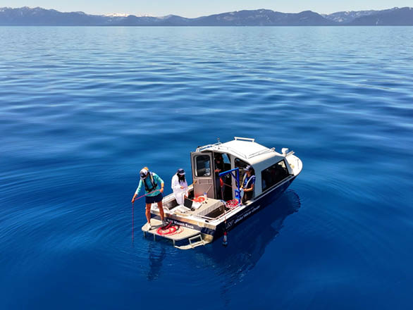 Researchers collect live water data on a boat in Lake Tahoe.