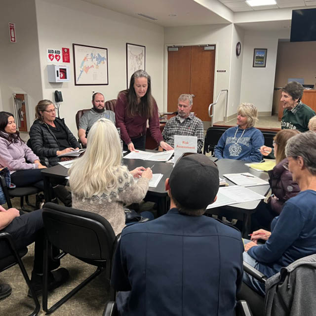 A group sits around a table discussing research.