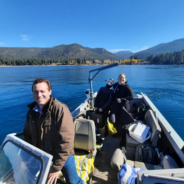 Two researchers sitting on a boat in Lake Tahoe.