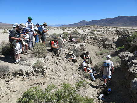 Field team in a desert arroyo that could flood suddenly during storms.