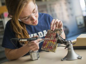 Person soldering a circuit board