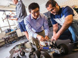 Three researchers in an unmanned autonomous systems engineering lab