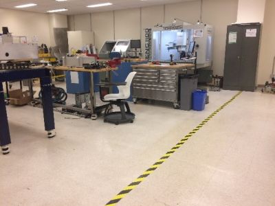 An example of a black and yellow safety line on the Makerspace floor