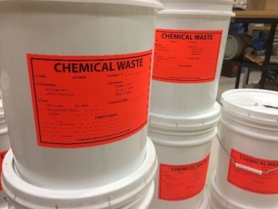 A bucket labeled "Chemical Waste"