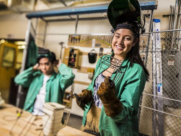 Art students working in a welding lab and wearing protective safety gear