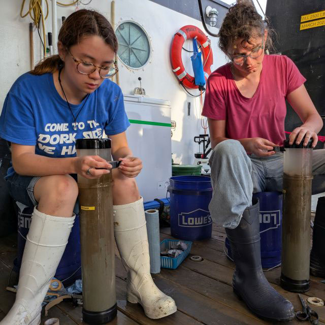 Student researchers handling and labeling the tubes full of deep-sea mud.