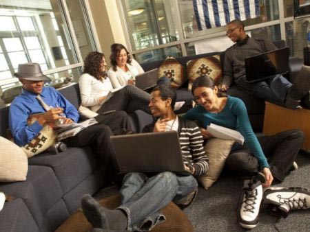 A gathering of students with laptops studying in the Joe Crowley Student Union