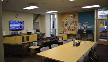 The Veteran and Military Center, with large study tables, a big TV and couches