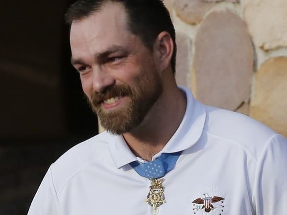 Clint Romesha smiling wearing the Medal of Honor around his neck
