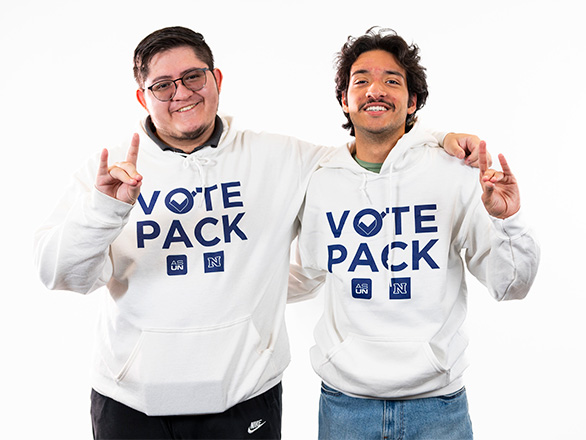 Two students wearing white "Vote Pack" sweatshirts and smiling.