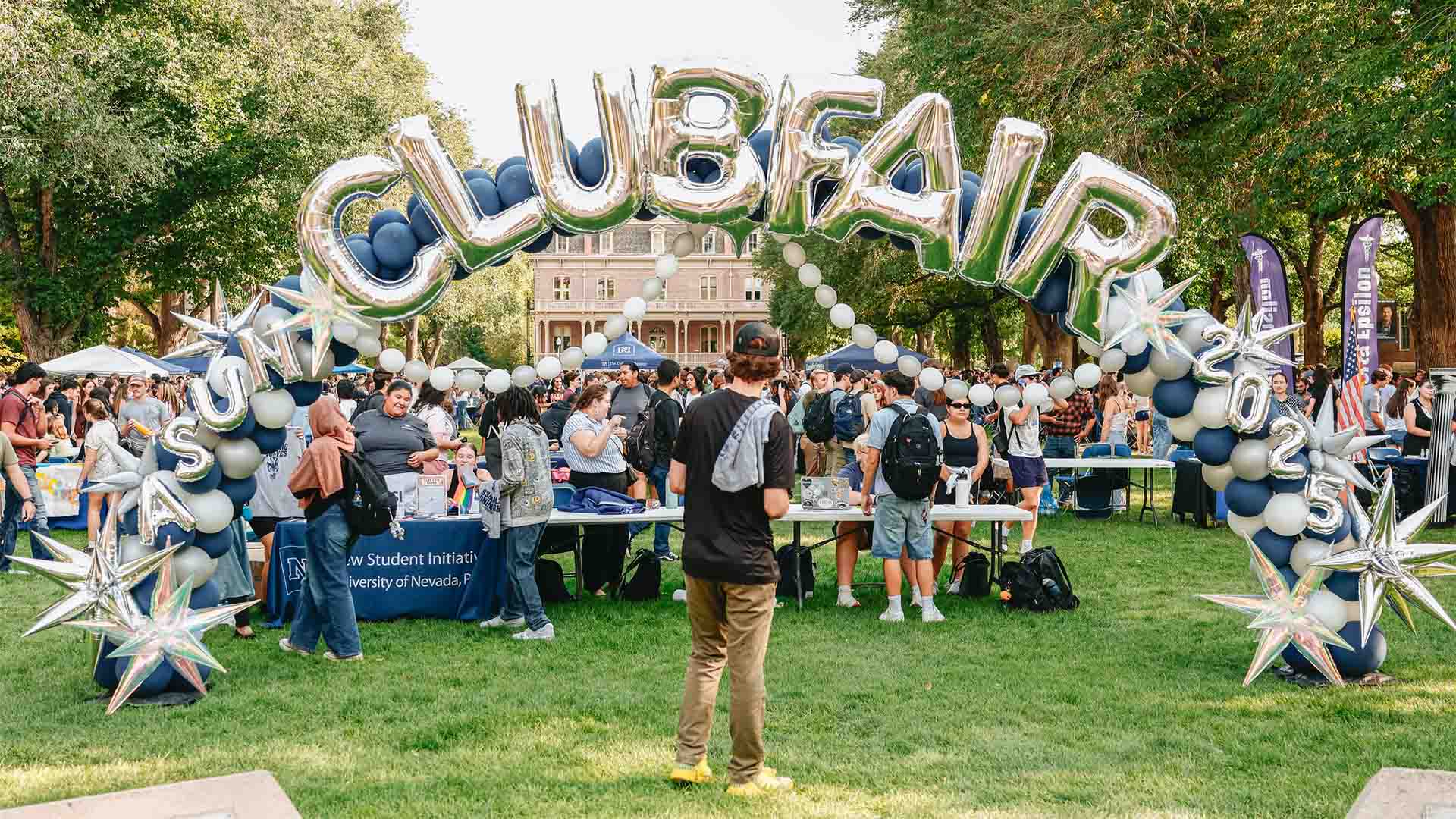 Club Fair on The Quad with attendees looking at tables. 