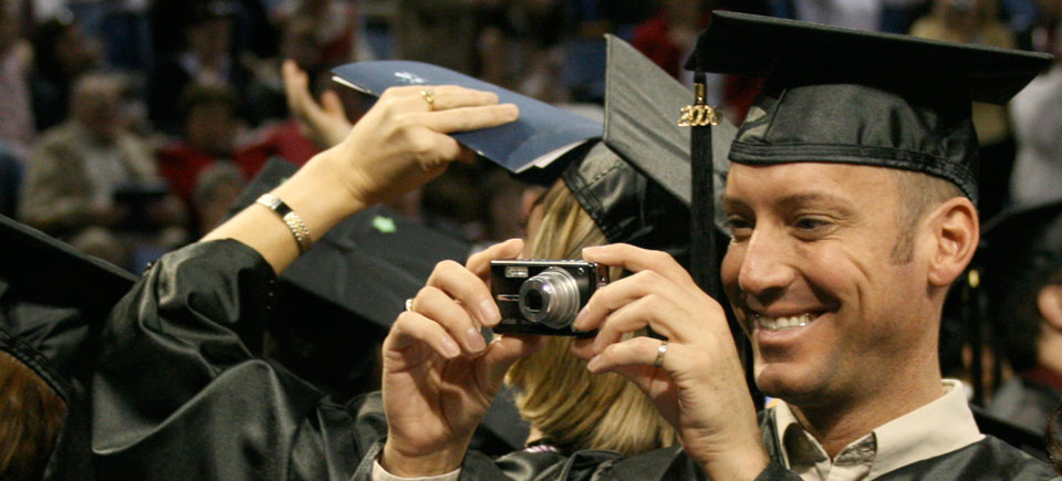 A graduate takes a picture