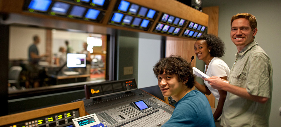 Journalism students in a control room