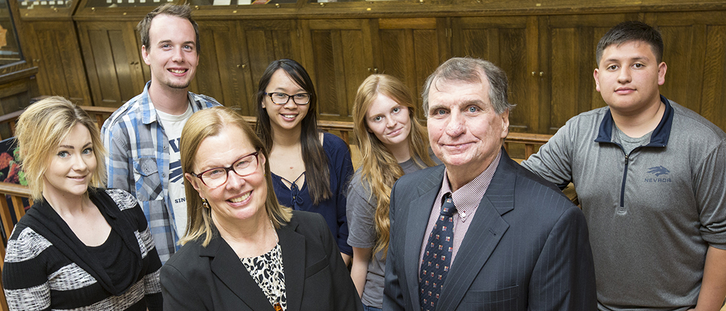 NevadaTeach co-directors Regina Temple and Robert Quinn stand surrounded by a group of college students.