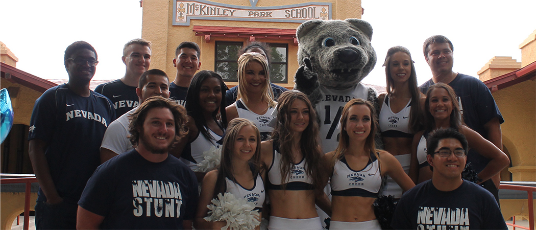 A group of cheerleaders standing with Alphie, Jr., the UNR mascot