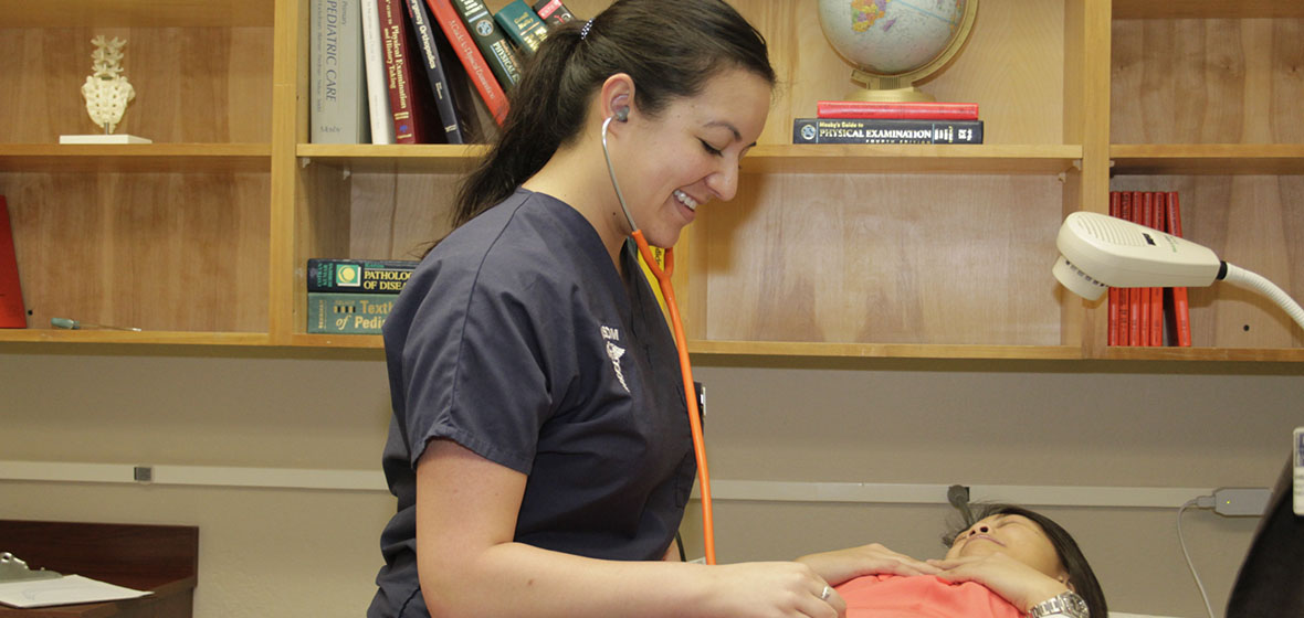 Medical student examining a "patient"