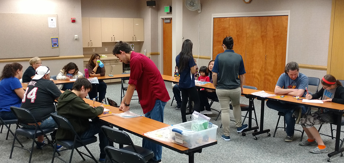 University students help participants during Mobile Engineering Education Lab at the Northwest Reno Library, May 21.